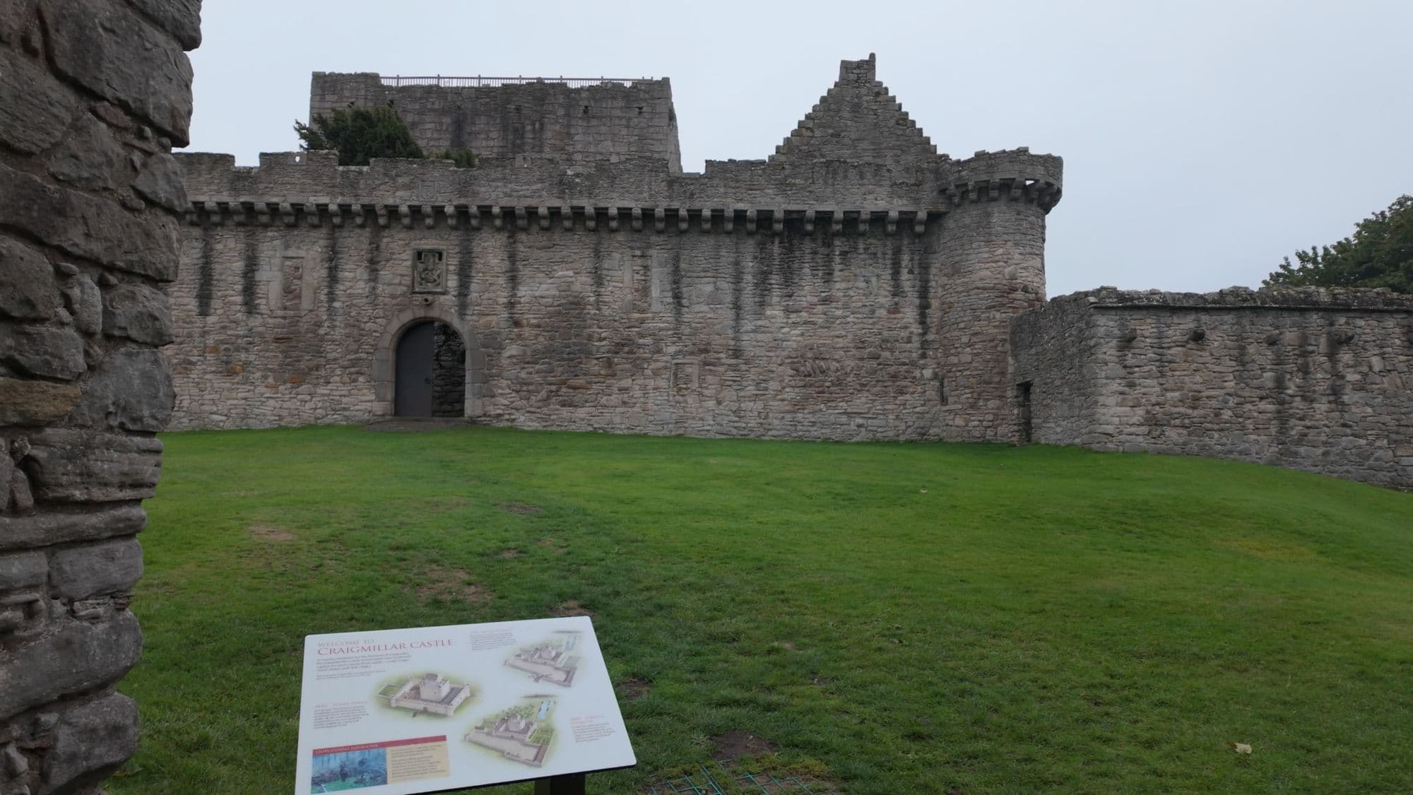 The Historic Environment Scotland information board on the lawn in front of the castle's curtain wall