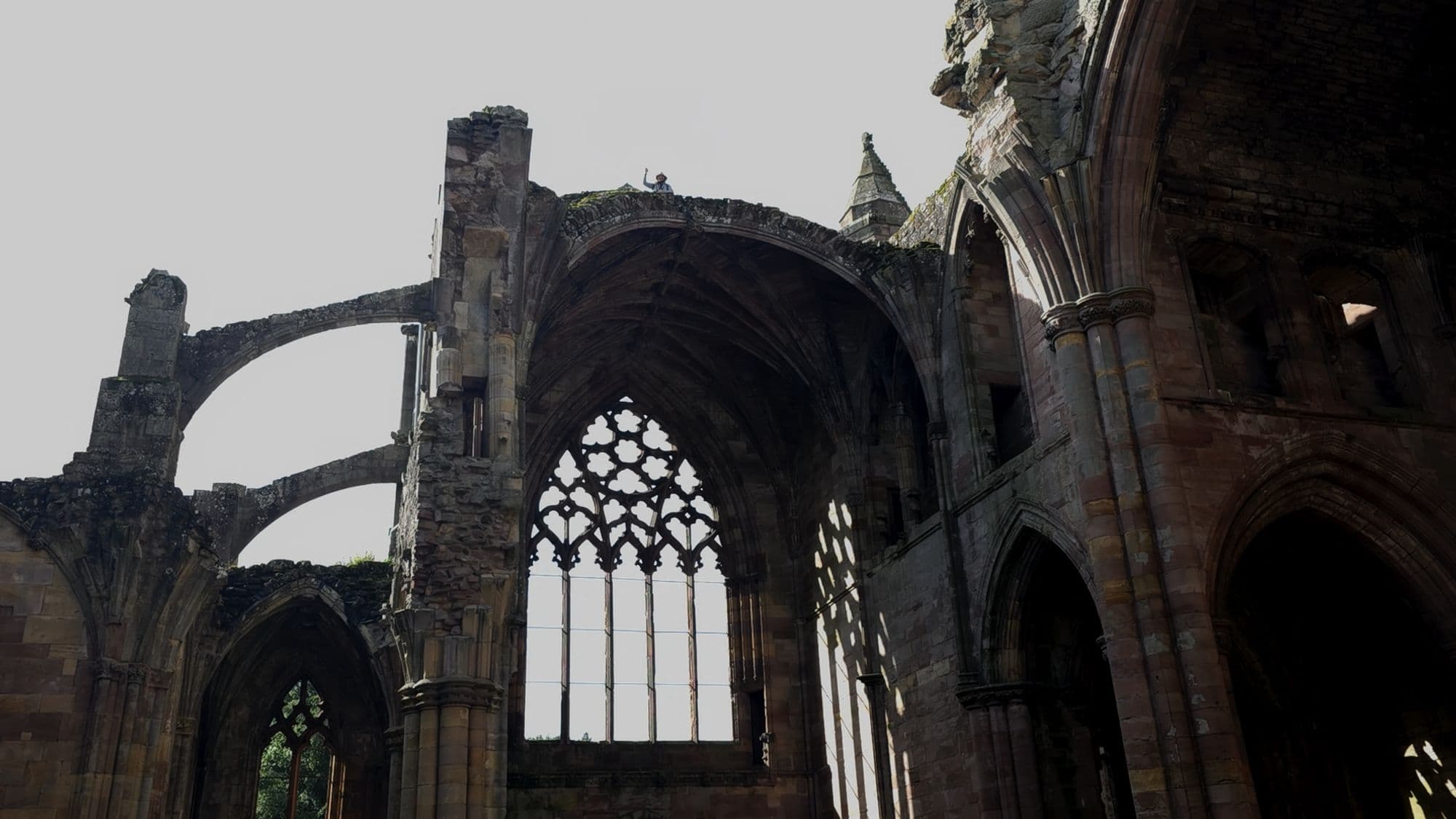 Flying buttresses and the great window at the east end of Melrose, seen from inside the ruin