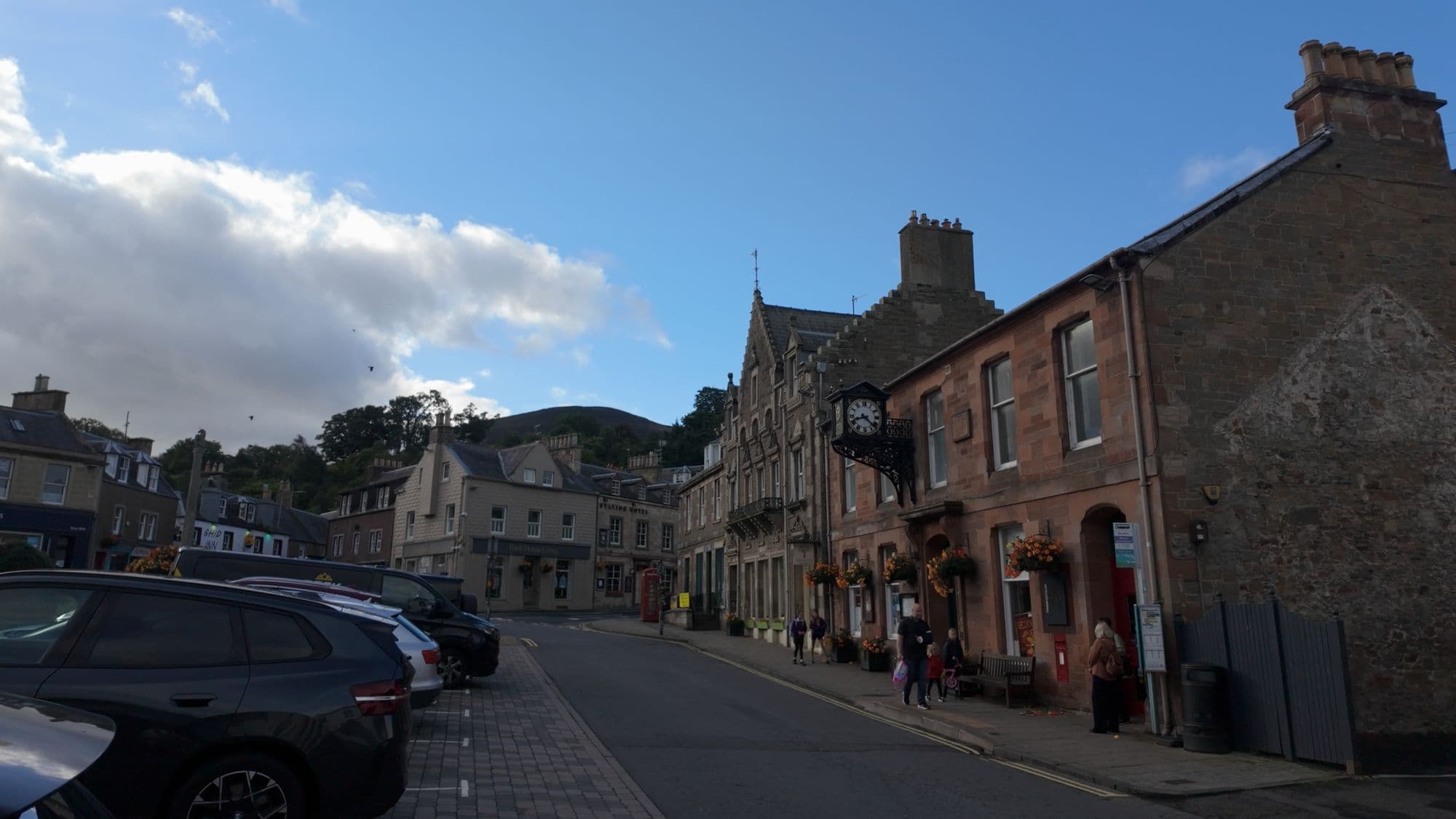 Sandstone shops and a hotel along the main street of Melrose, the hills rising behind the town
