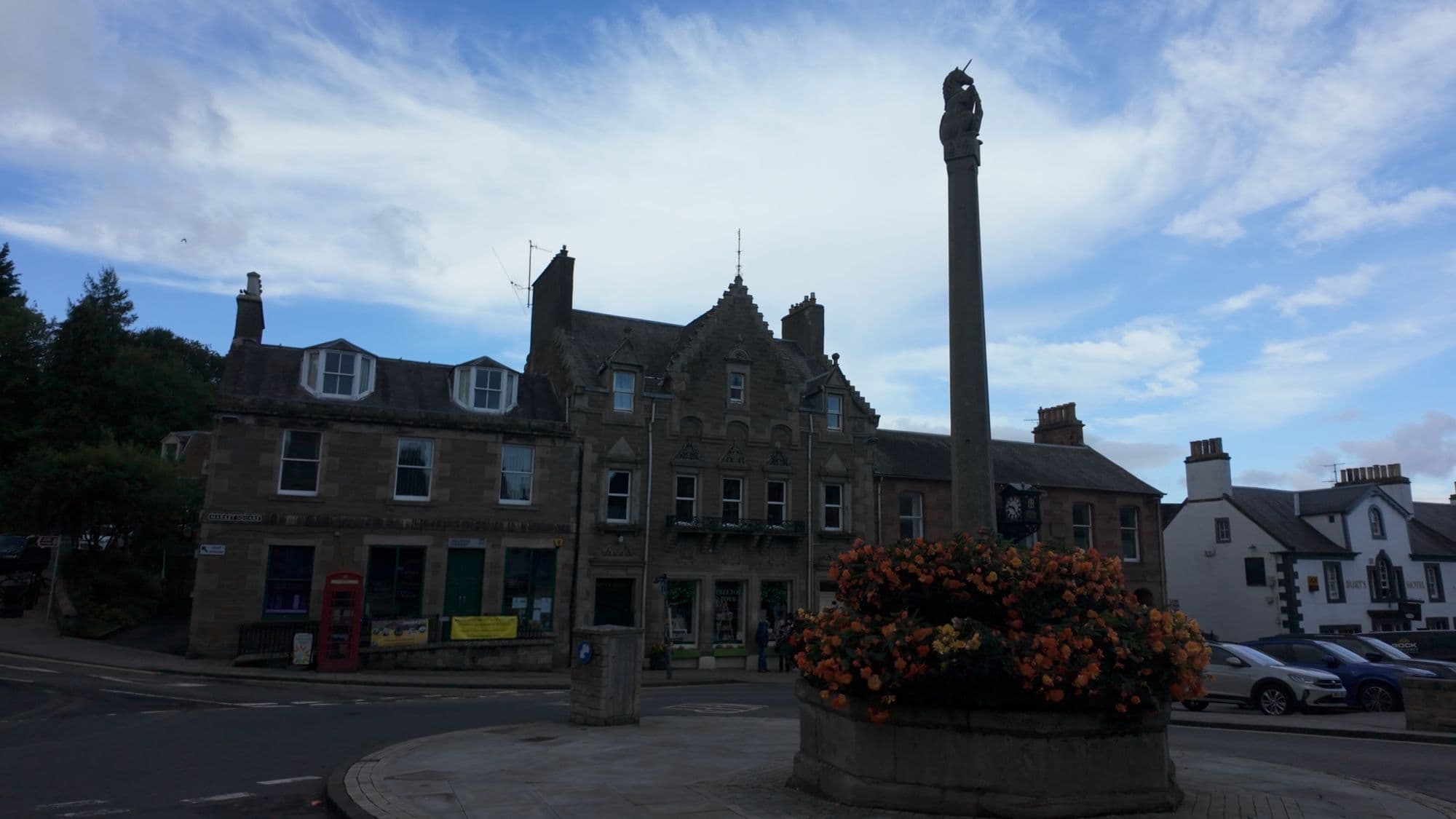Melrose's market square, with the tall mercat cross standing over a bed of flowers