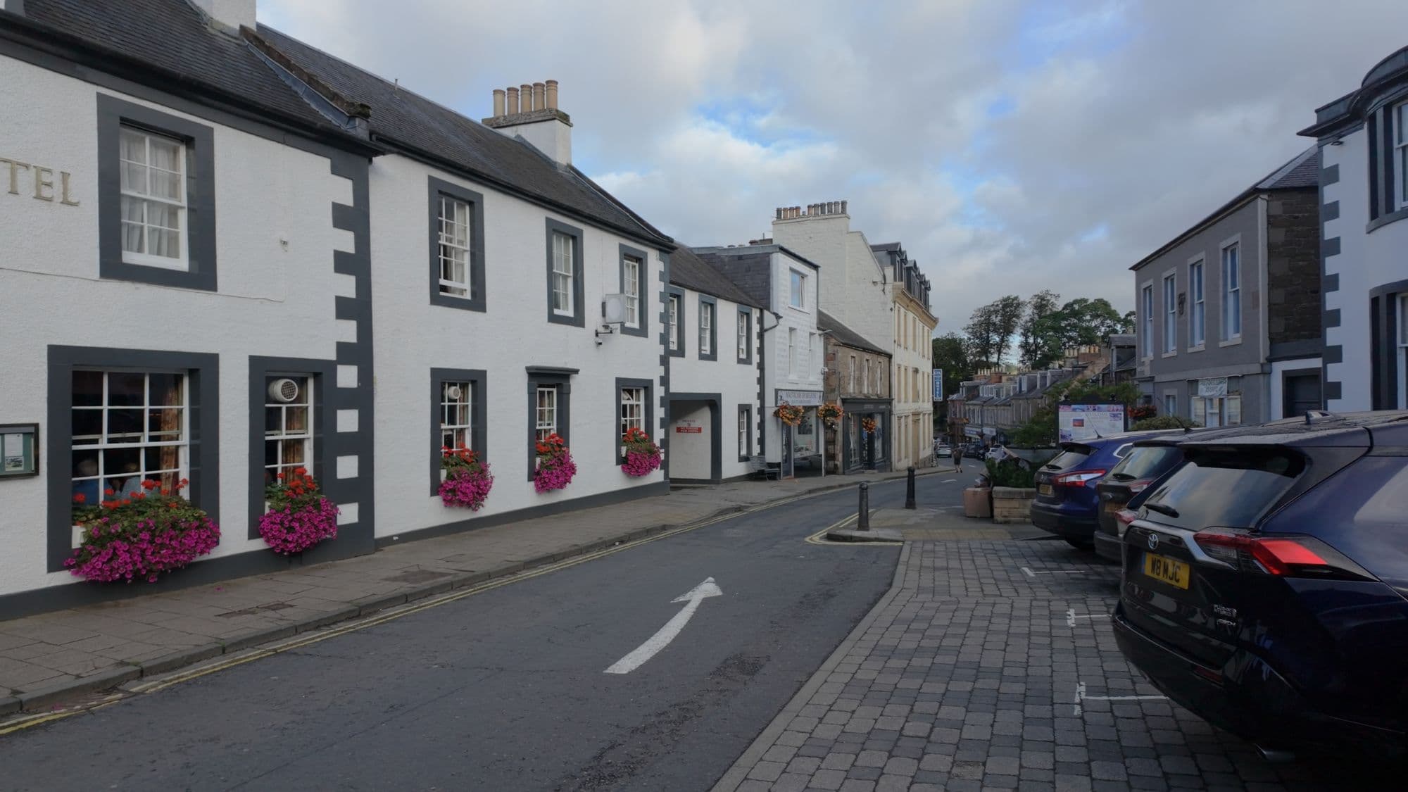 Whitewashed buildings with window boxes along the main street in Melrose
