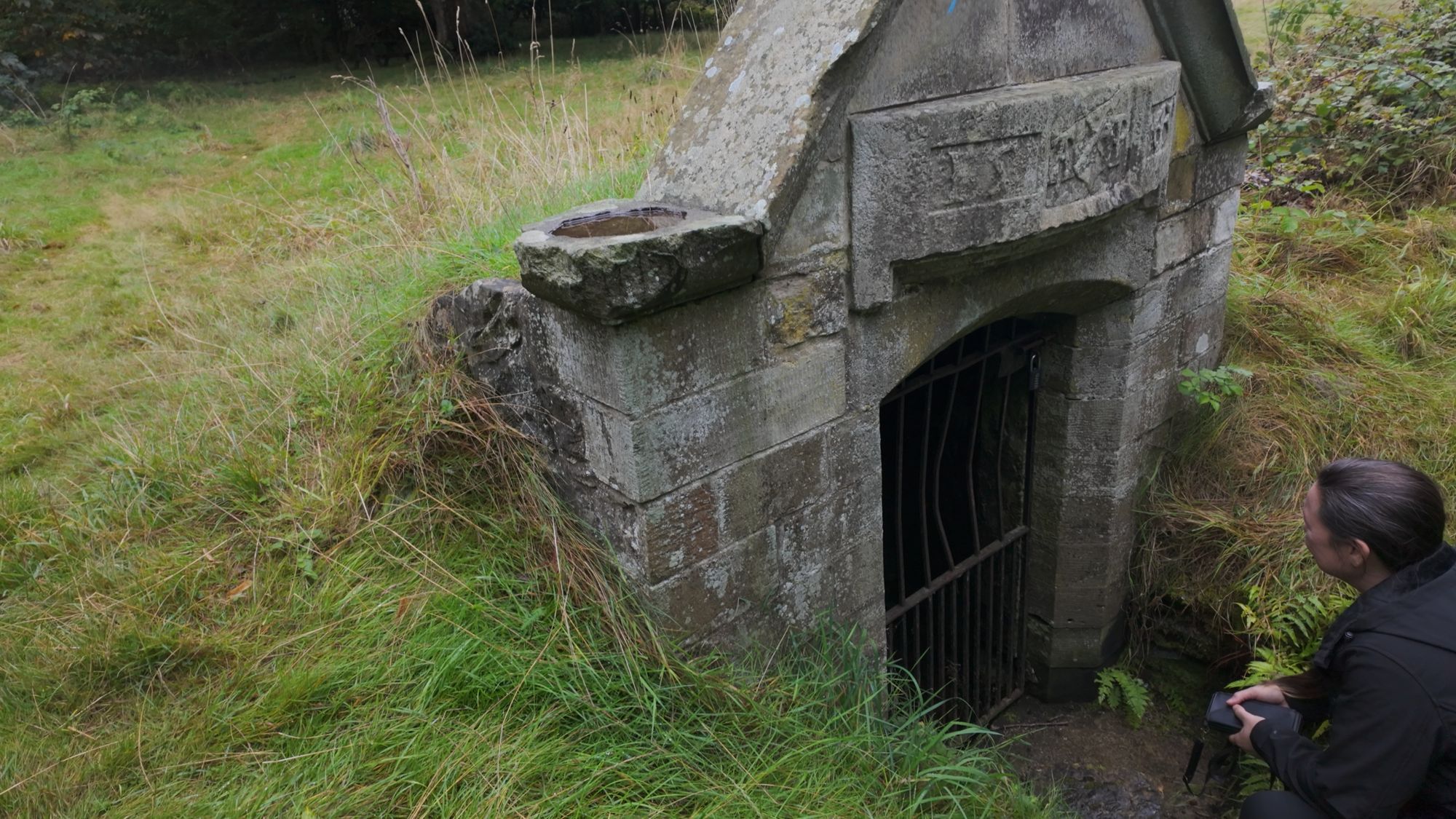 My sister crouched at the barred door of the Balm Well, peering in at the water