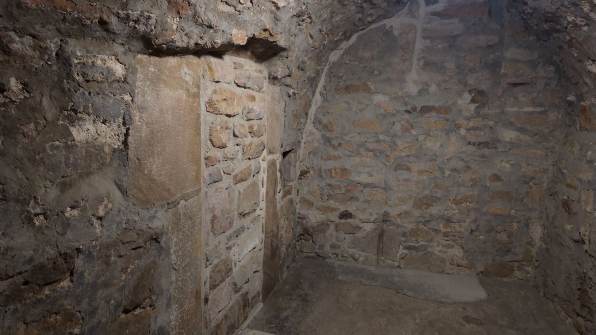 A section of patched, newer-looking stonework set into an older wall in Craigmillar's lower levels