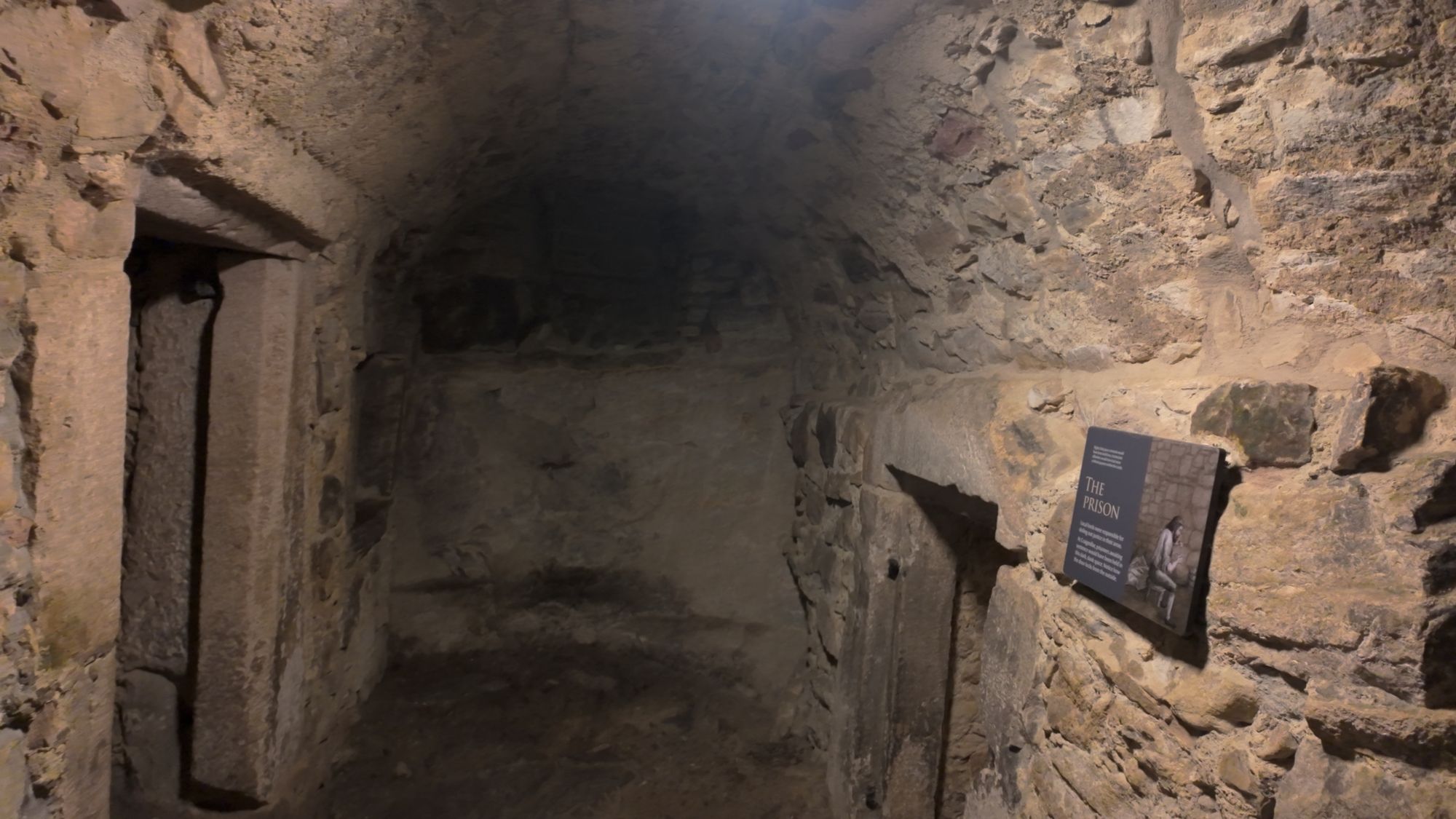 The prison in Craigmillar's lower levels — a dim, bare stone chamber with a narrow doorway