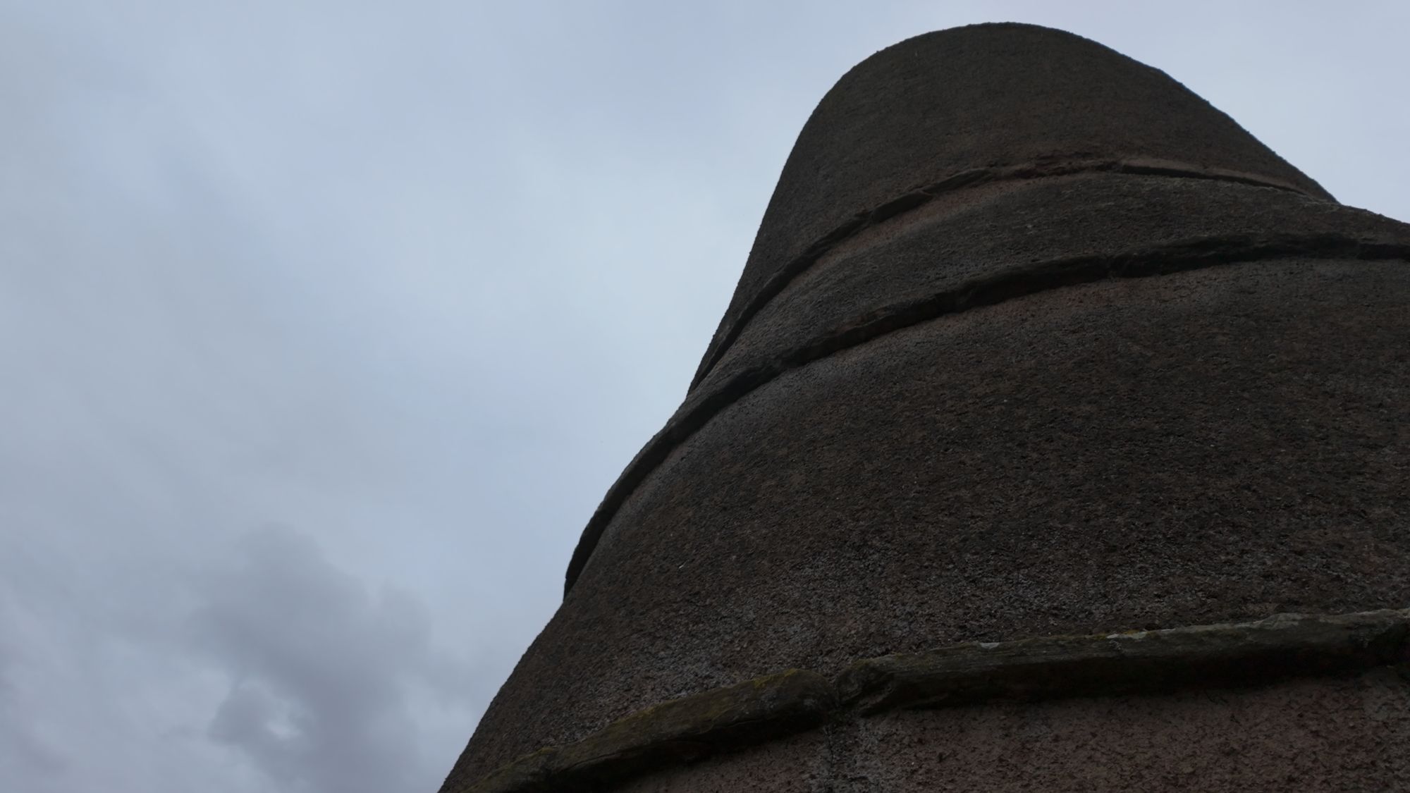 Looking up the side of the doocot at the projecting stone bands — rat guards or perches, depending on who you ask