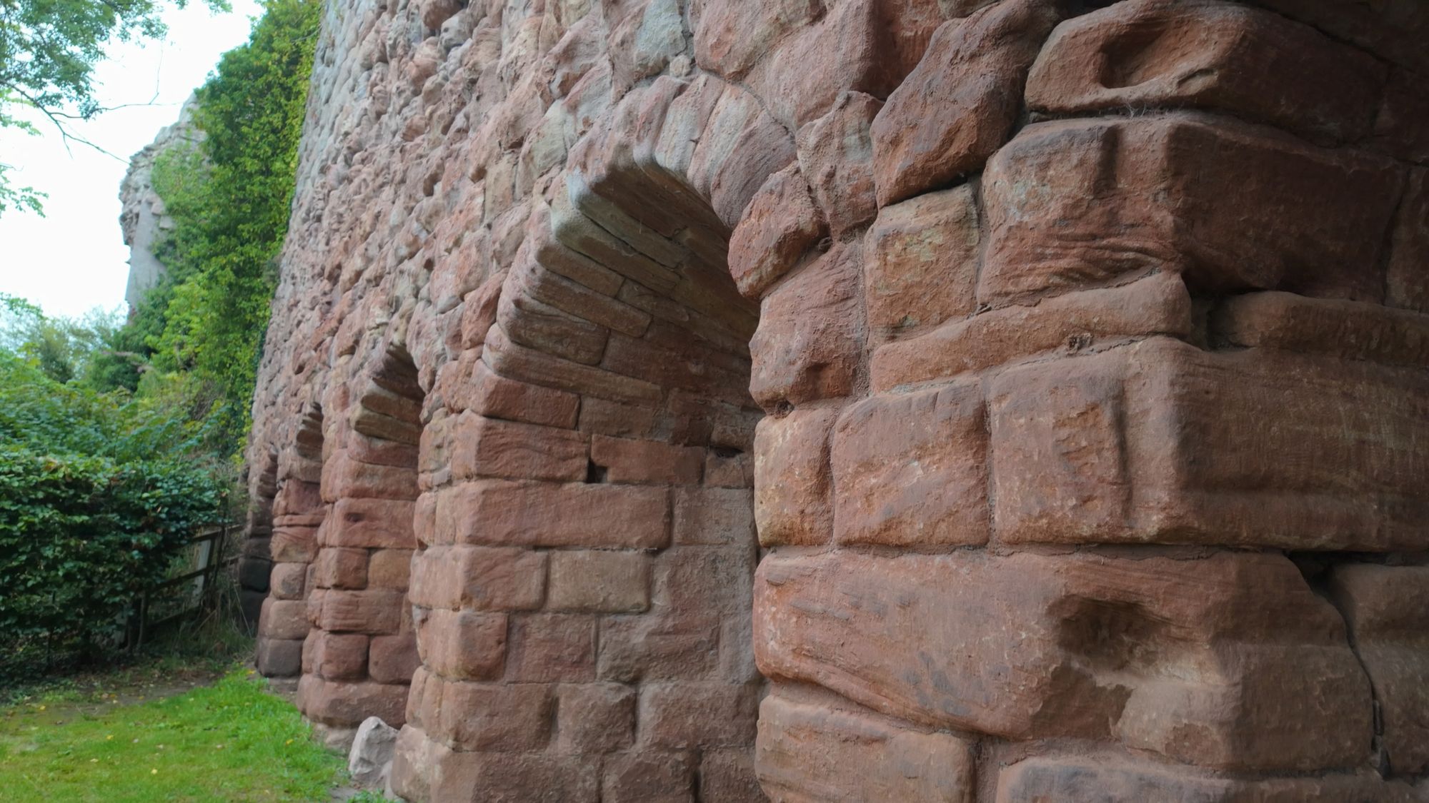 Massive red sandstone arches in the lower walls of Rosslyn Castle, built down into the rock