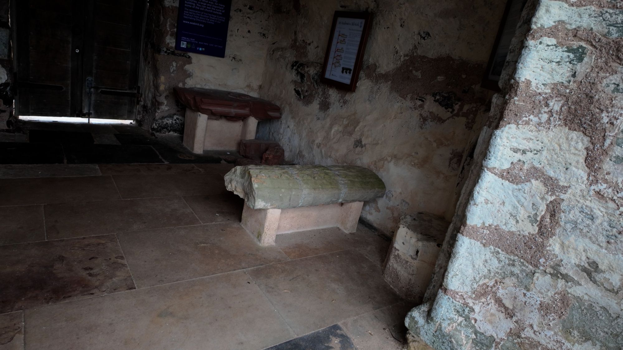 The mortsafe I could see through the bars: a heavy stone block resting inside the walls of the old church