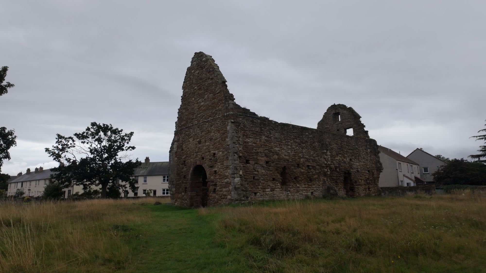 St Martin's Kirk standing roofless and alone in a grassy field on the edge of Haddington