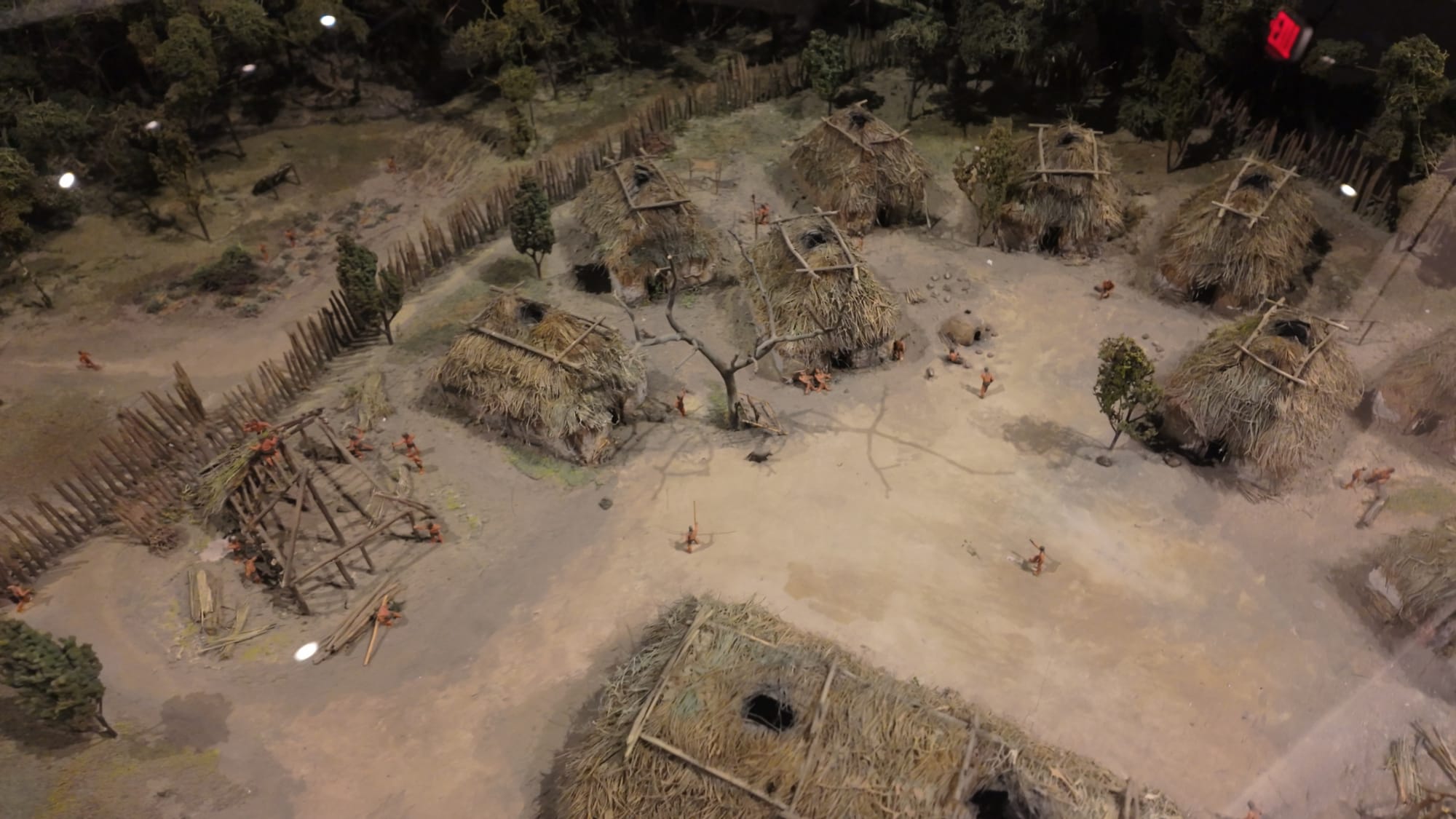 A detailed diorama of a Fort Ancient culture village — thatched houses, a stockade, and daily life inside the old Hopewell walls around 1000 CE