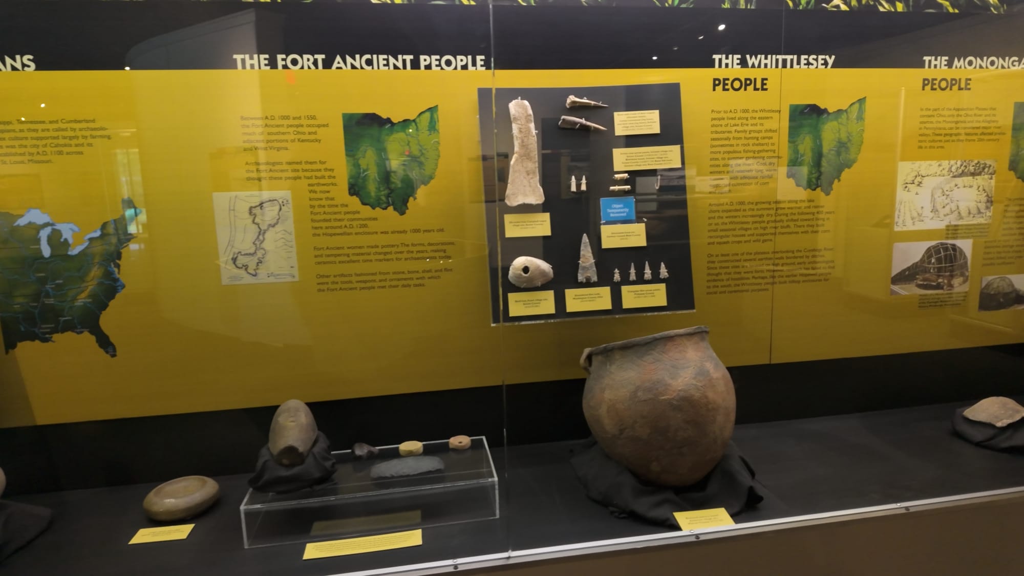 A museum case comparing the Fort Ancient, Whittlesey and Monongahela peoples, with a reconstructed cooking pot