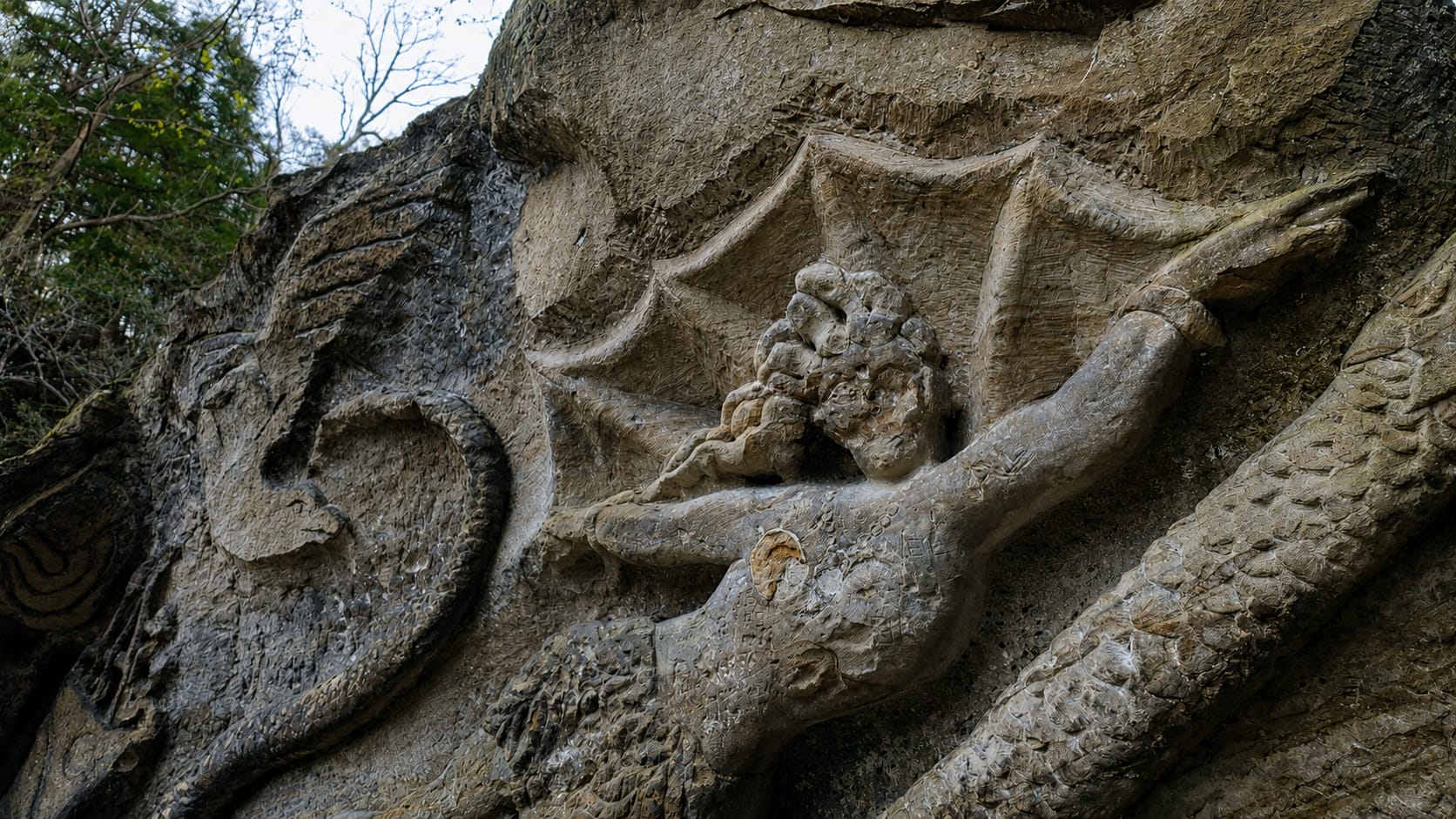 Detail of the central Native American figure and the carved eagle on the main face