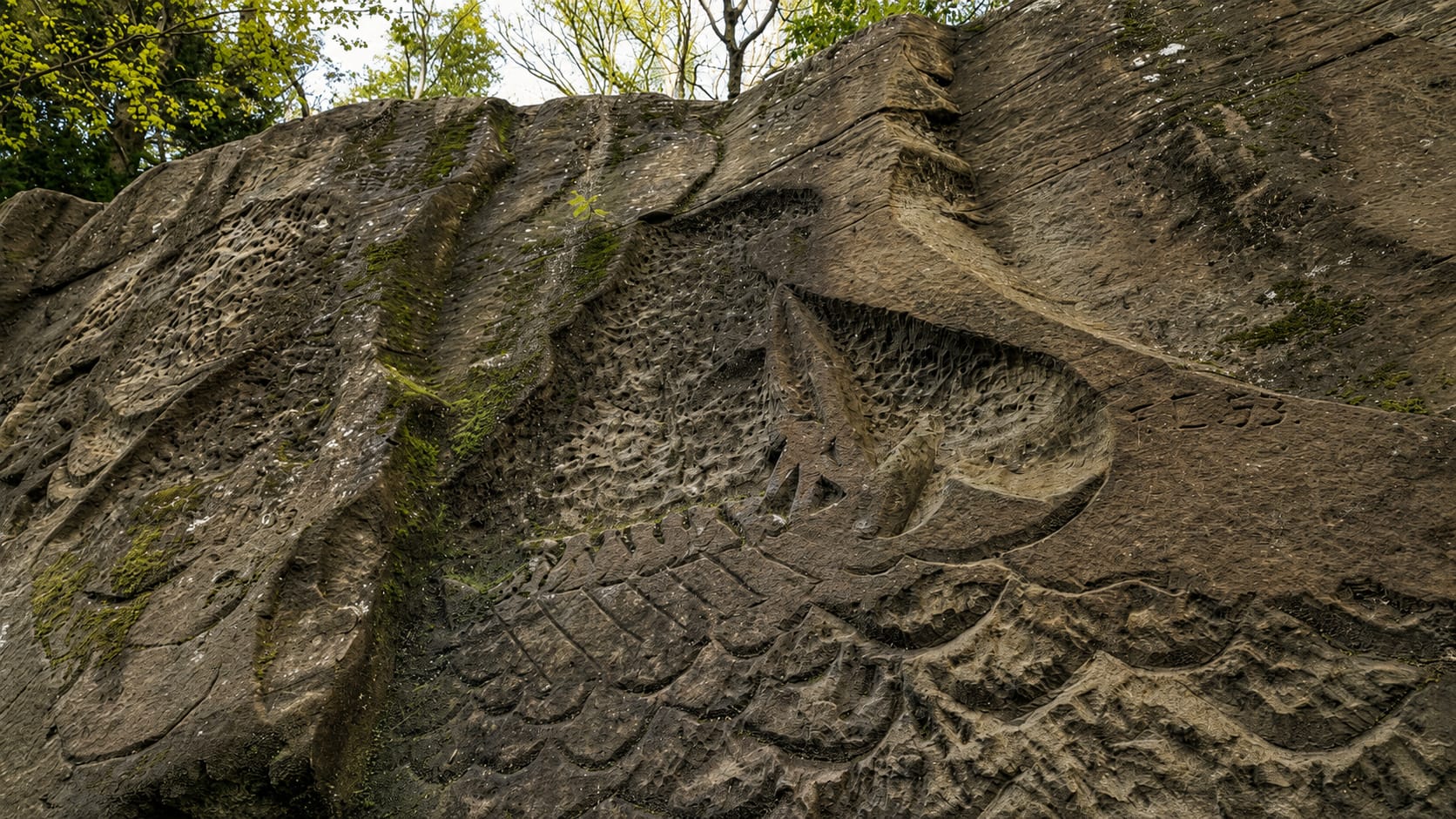 The woodsman felling a tree, carved into the river-facing side of the rock