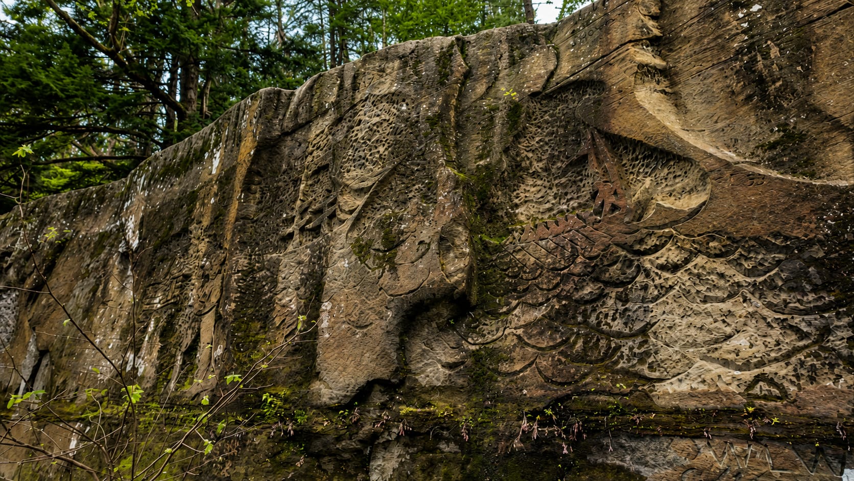 The unfinished river-facing side of Henry Church Jr. Rock, where the carving is rougher and the work stopped