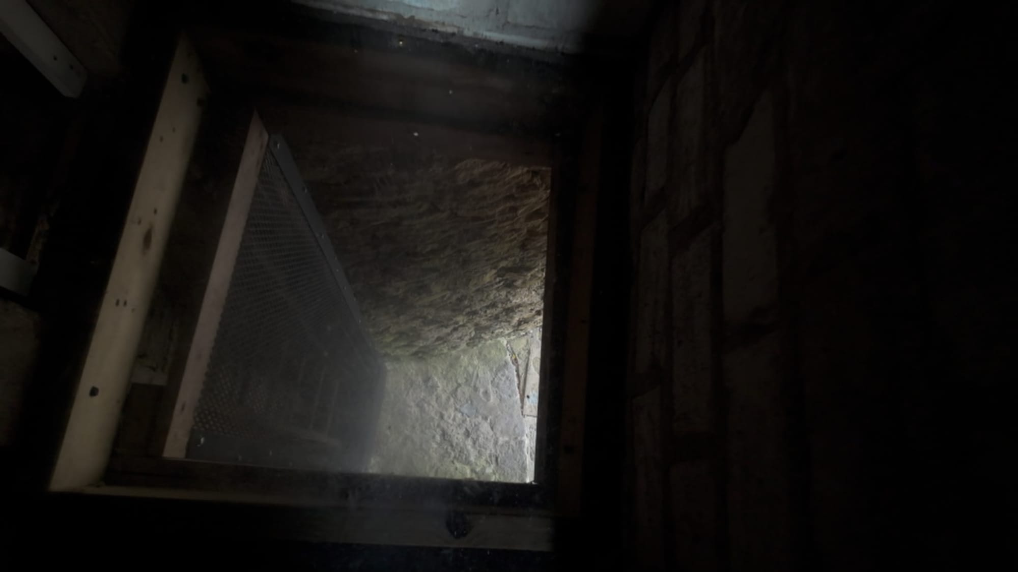 A murder hole above the entrance — a functional gap for defending the door from above