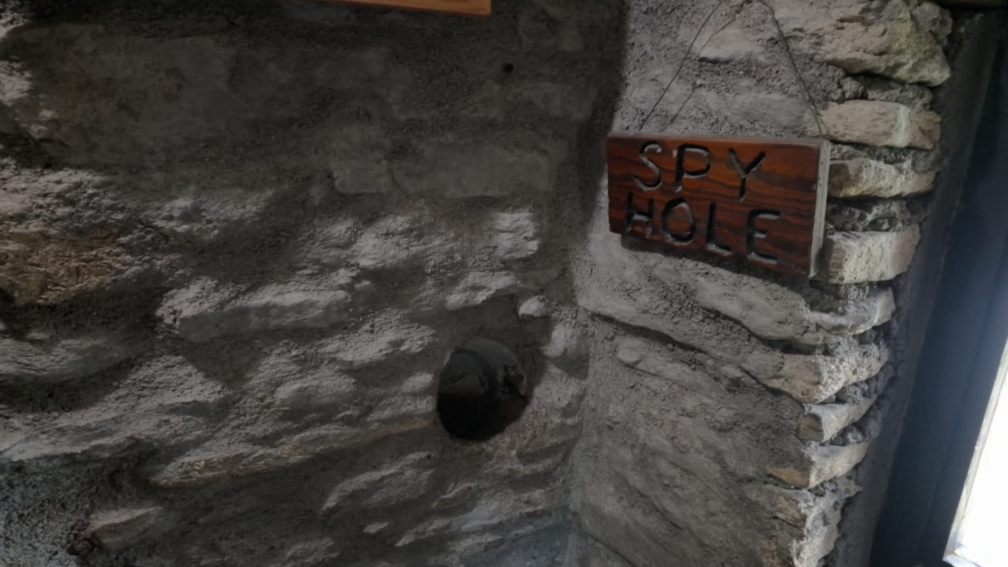 The spy hole — positioned to watch the entrance and the floor below without being seen