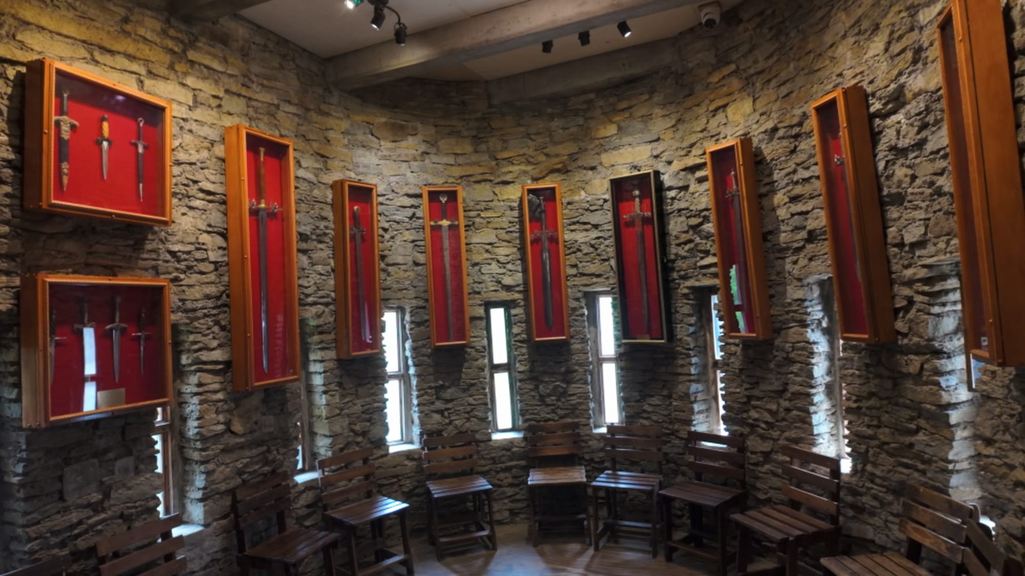The castle ballroom, modeled on a room in the Château de la Roche in France, now housing part of the sword collection
