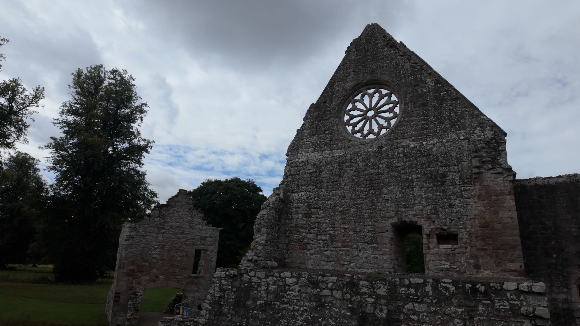 The refectory gable at Dryburgh with its round rose window, standing alone above the ruined walls