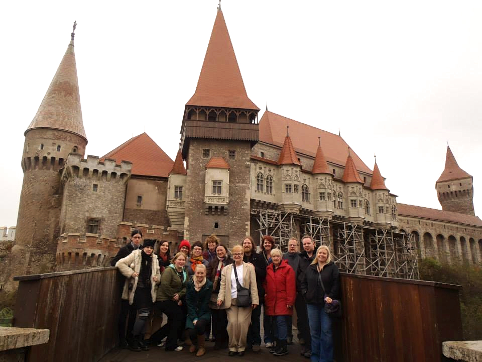 The whole group in front of Corvin Castle — before the costumes came out
