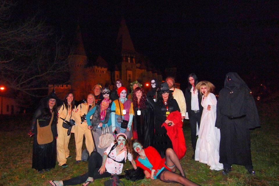 The group in costume outside Corvin Castle at night — that's the castle behind us