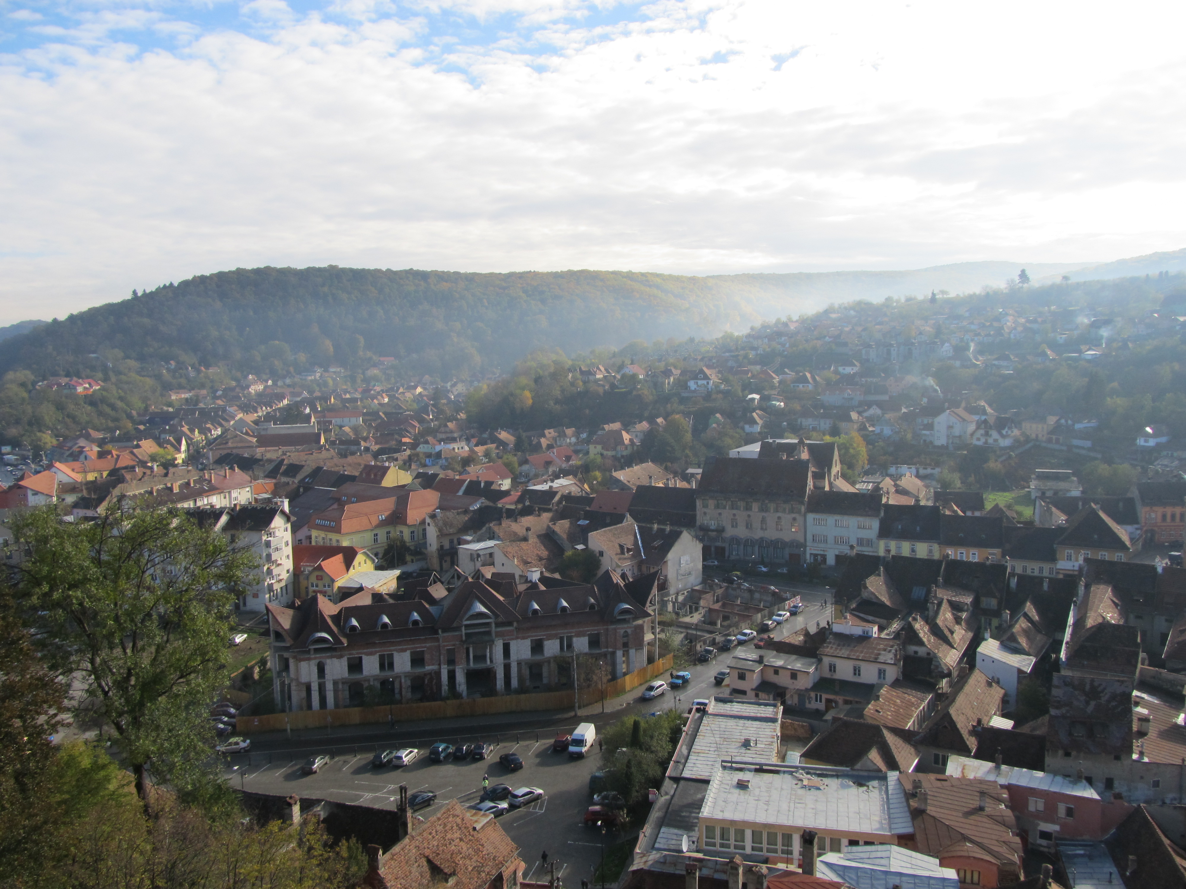 Sighișoara from above — a UNESCO citadel with mountains and mist