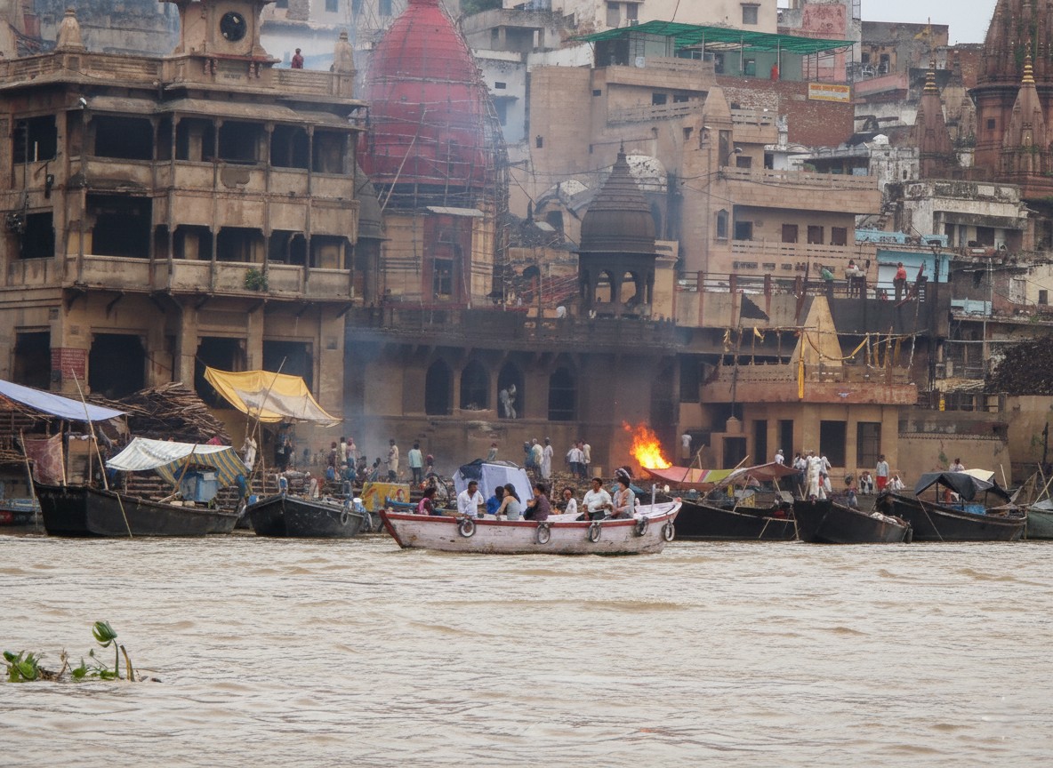 The ghats of Varanasi from the river — the steps, the city, the whole thing