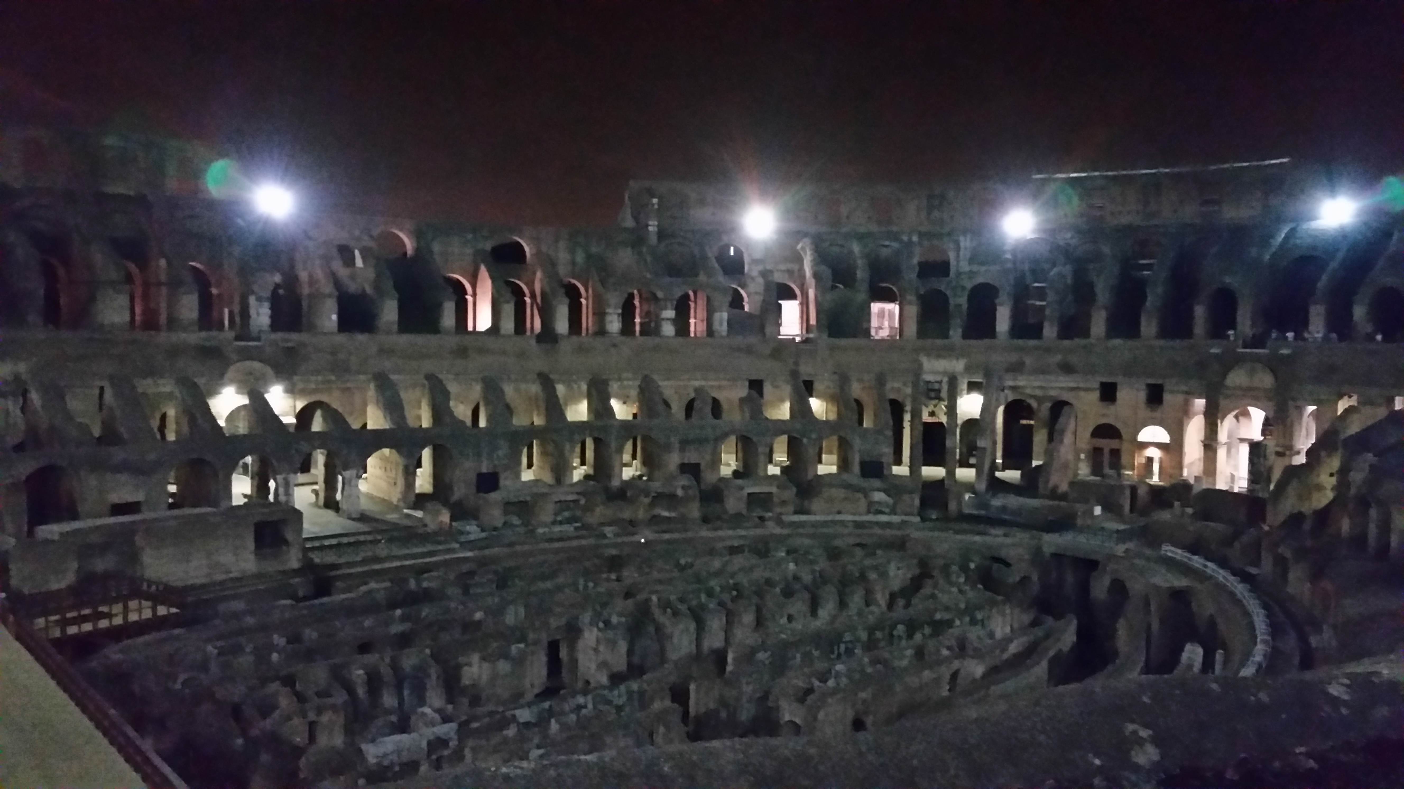 The Colosseum lit up at night in Rome, Italy