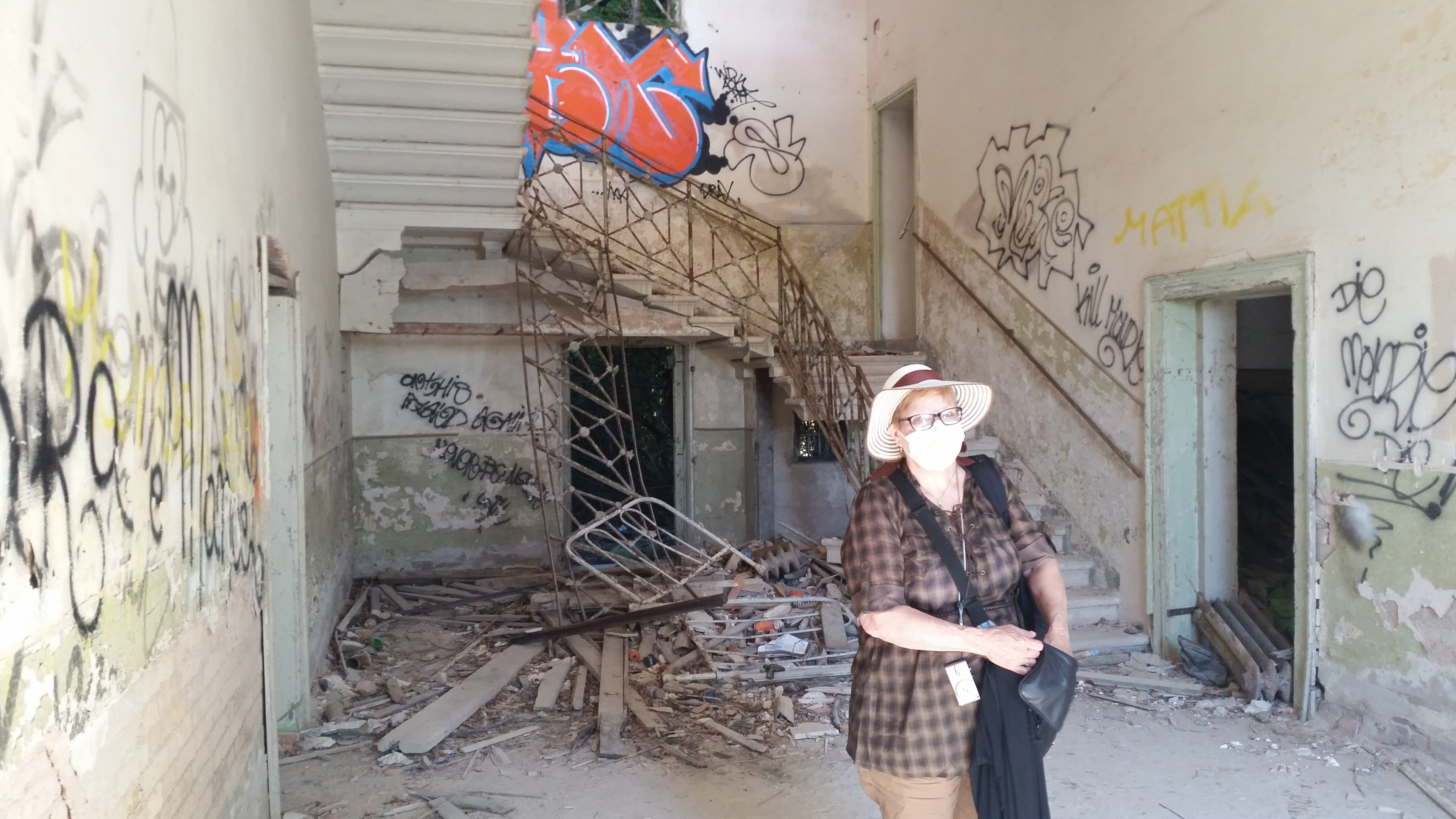 My mom wearing a mask inside the abandoned hospital on Poveglia