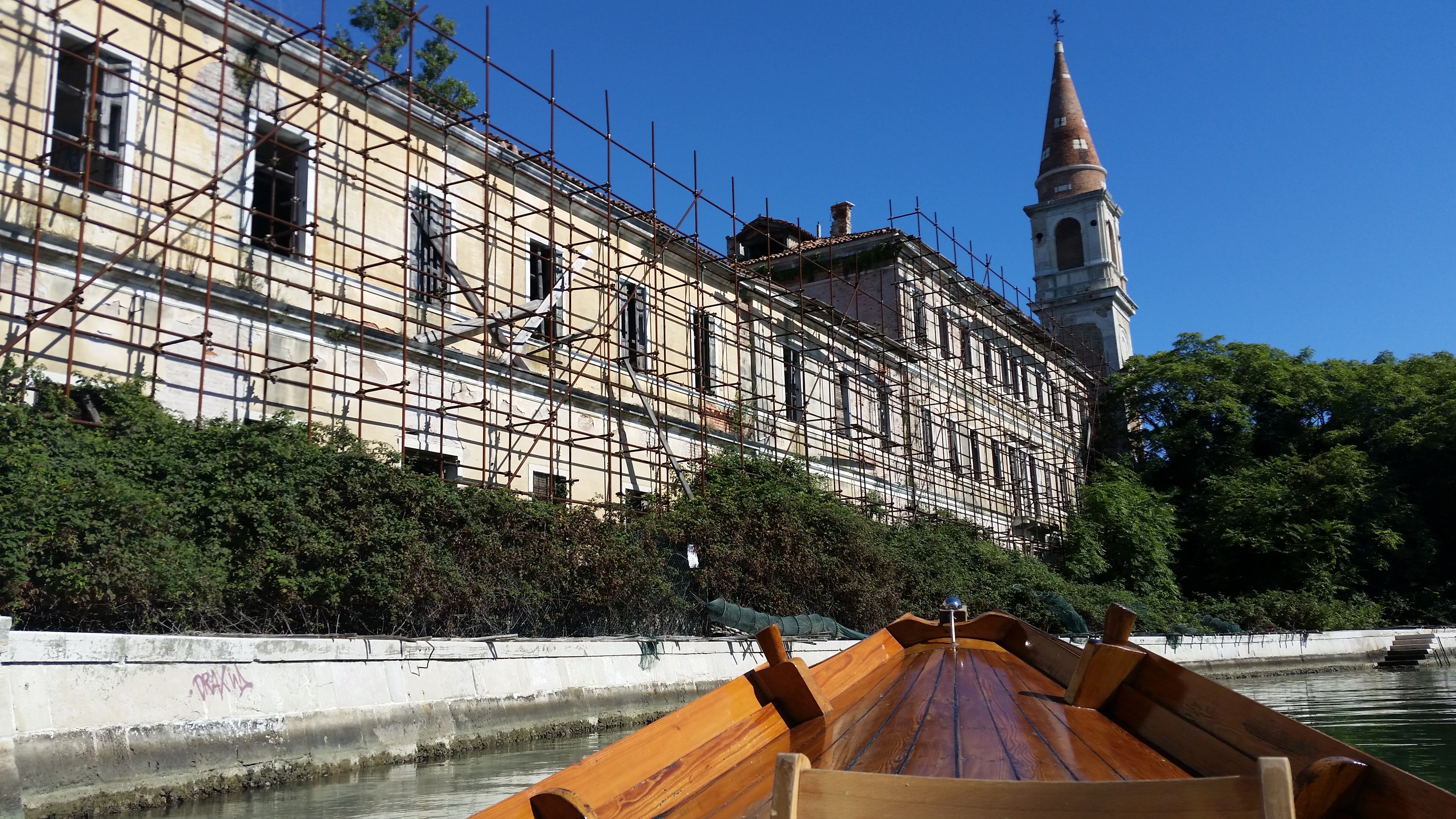 Poveglia island and its collapsed bell tower seen from the water