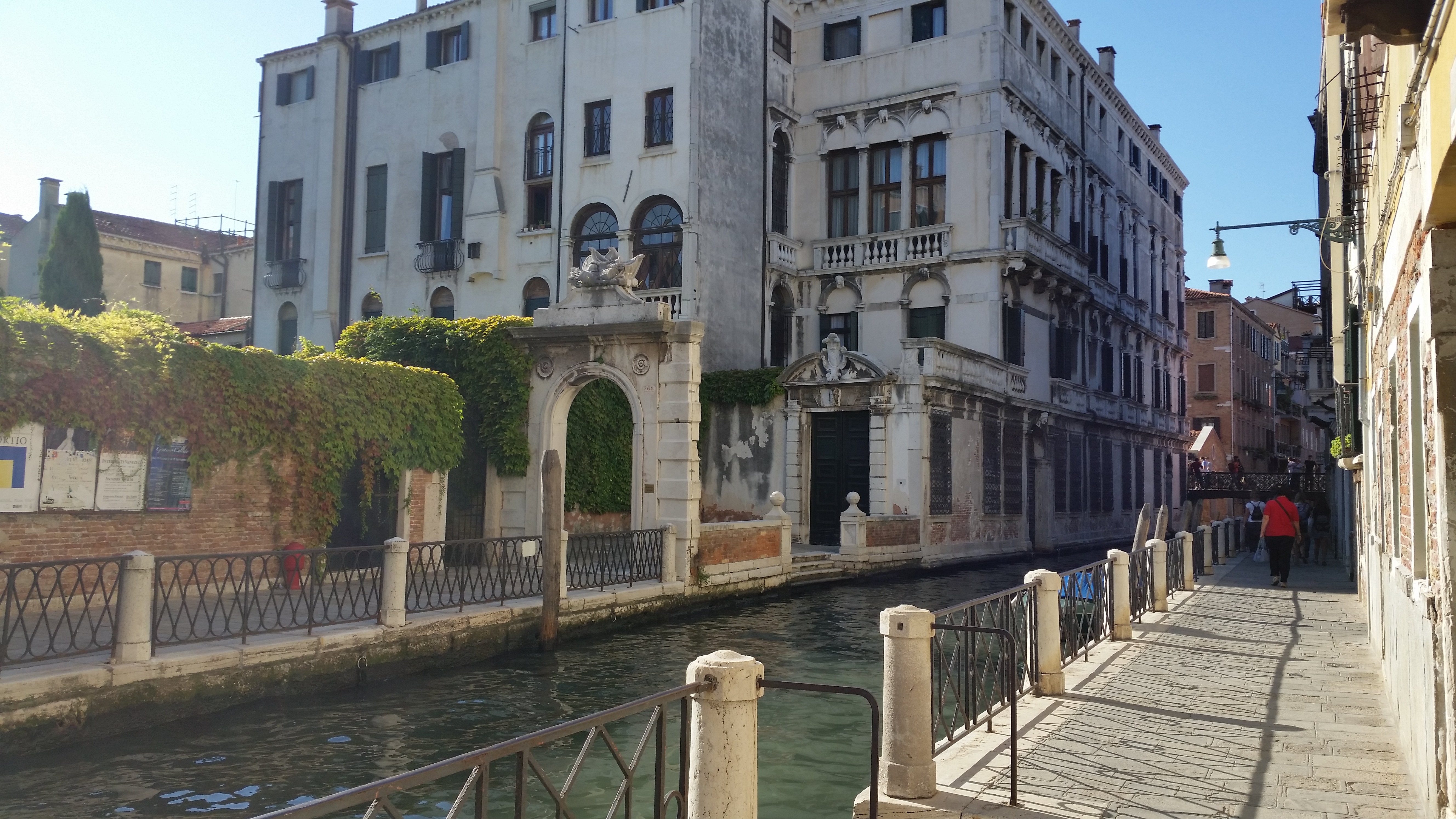 A quiet canal winding between old buildings in Venice, Italy