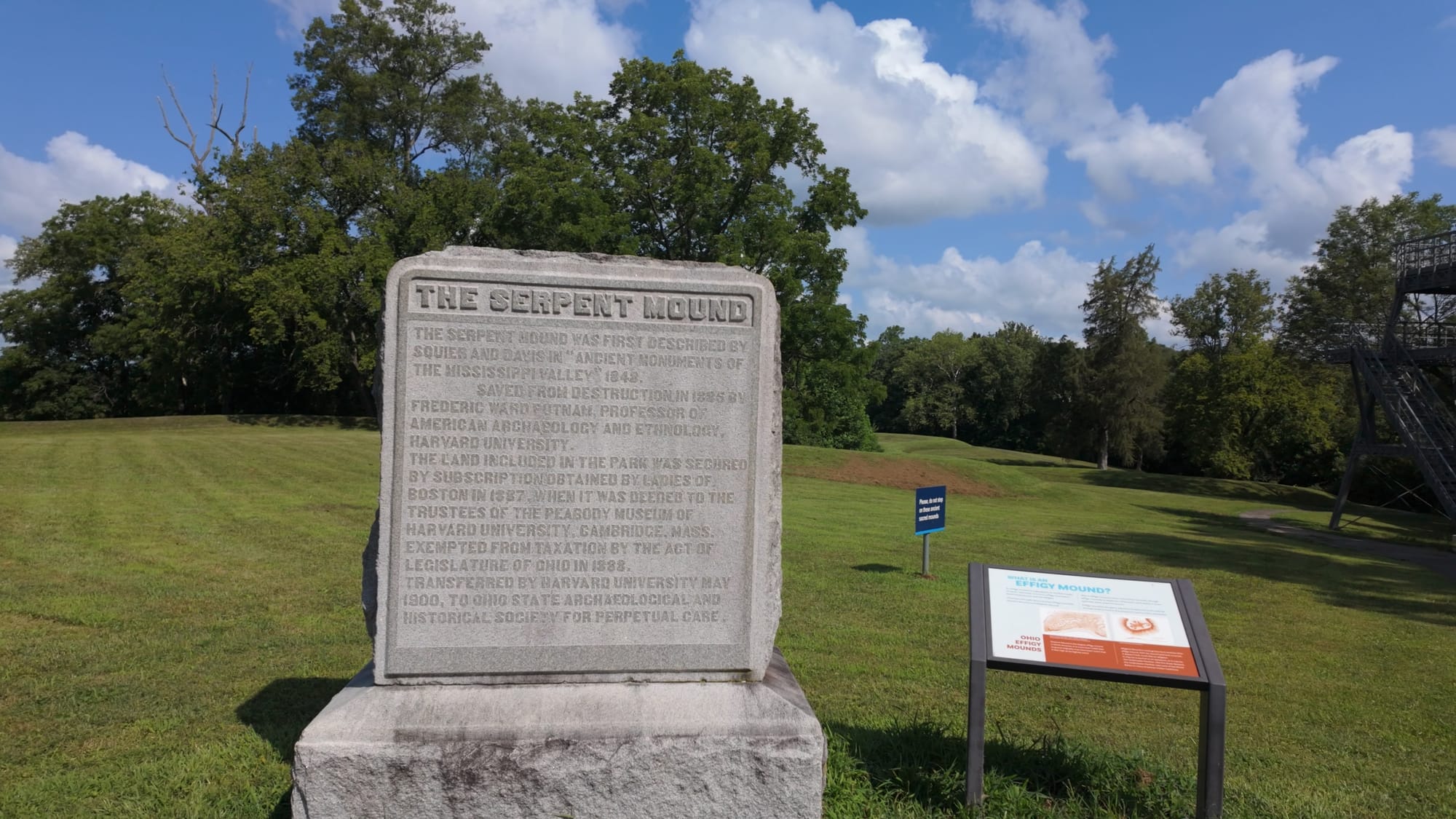 The monument stone at Serpent Mound, engraved with the site's 1886 rescue by Putnam and the 1887 purchase funded by subscription