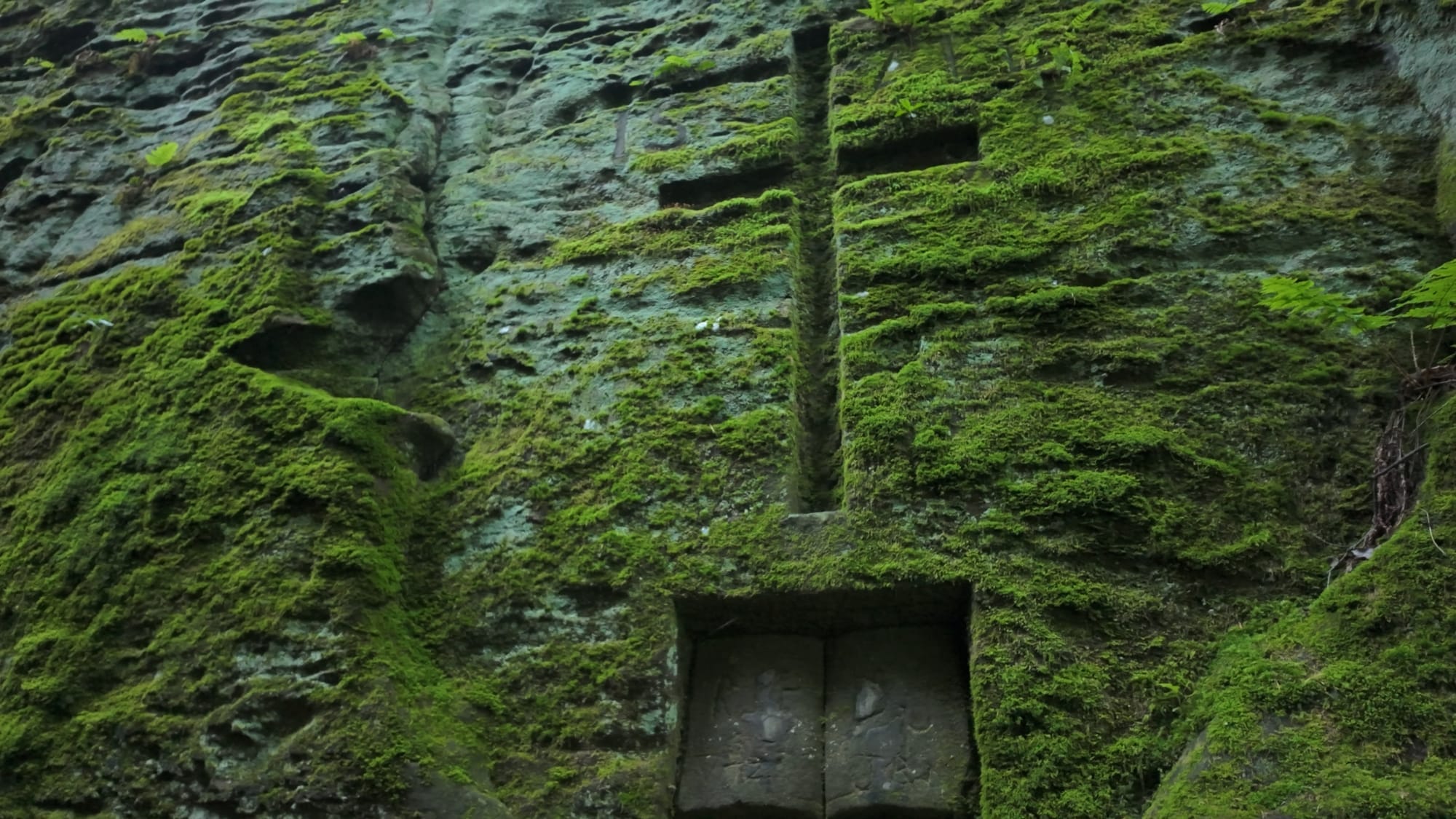 A closer look at the open Bible Noble Stuart carved into the sandstone